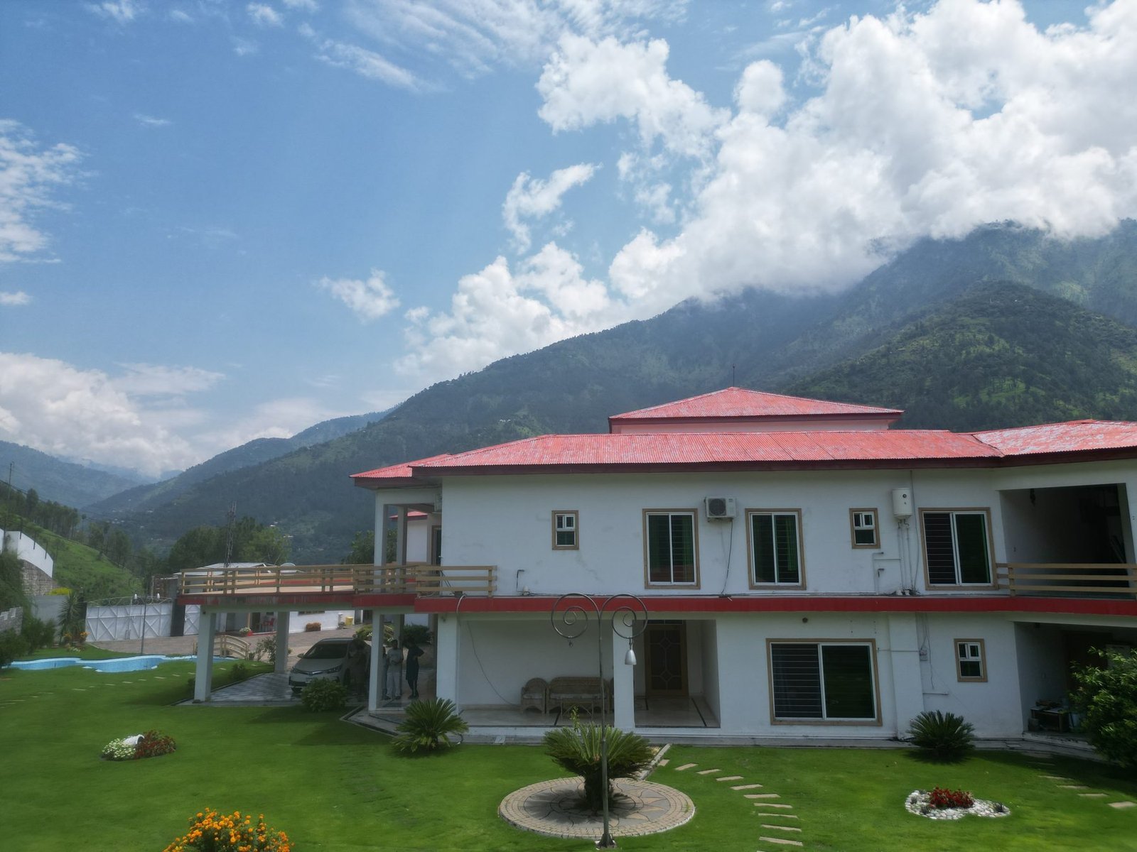 Lodge exterior with mountain backdrop and blue sky